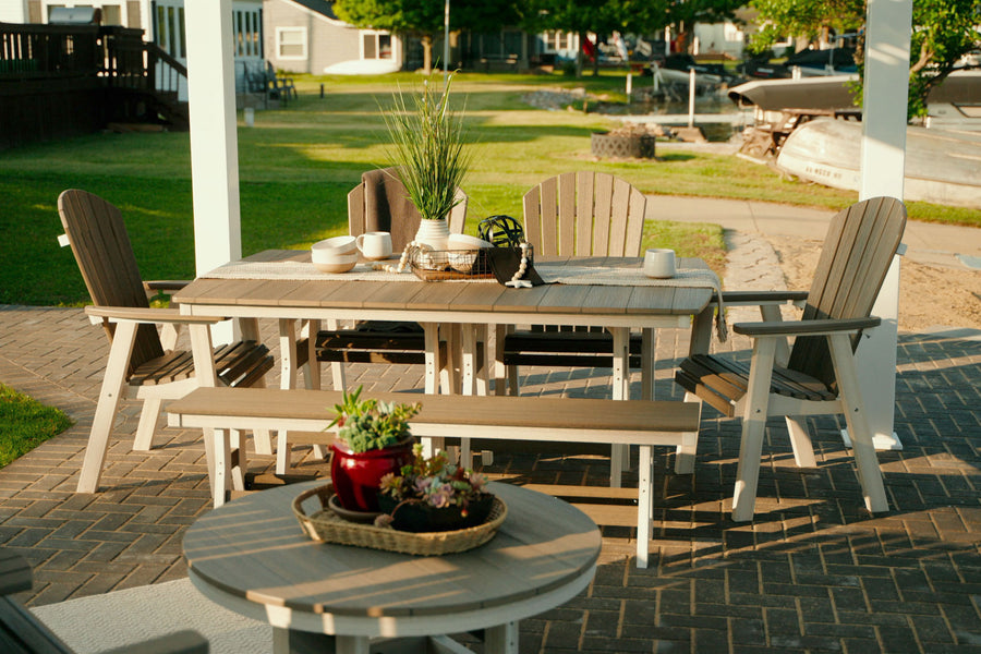 Poly Outdoor Furniture on a lake home patio. Outdoor table with bench and chairs, rockers, and coffee table.
