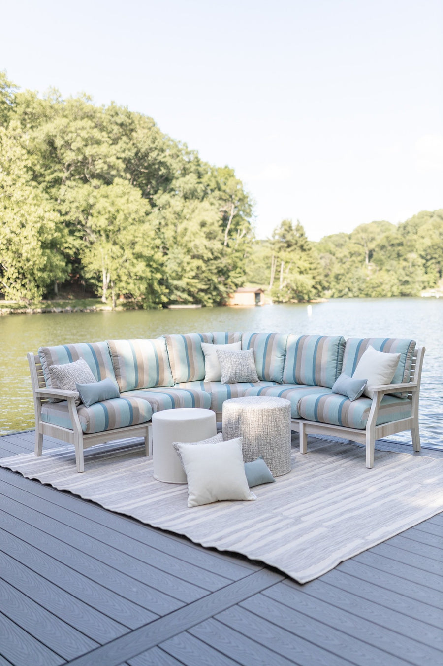 Classic Terrace Sectional with striped cushions in Gateway Mist color, set on a dock overlooking a serene lake and surrounded by greenery, perfect for outdoor relaxation.